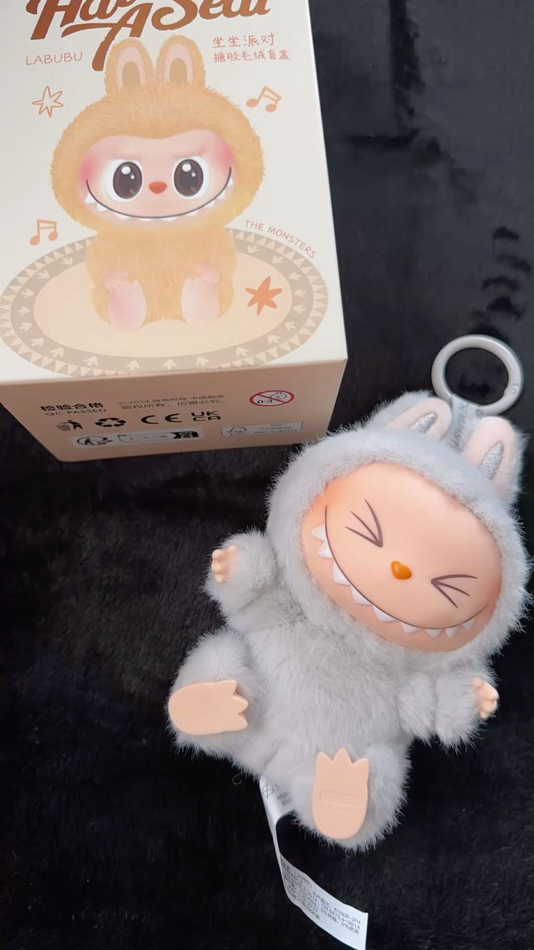 Plush toy with cartoon face and box in the background