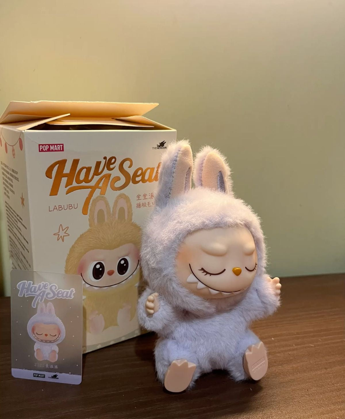 Plush toy resembling a character from 'Have a SeaT' with packaging in the background.